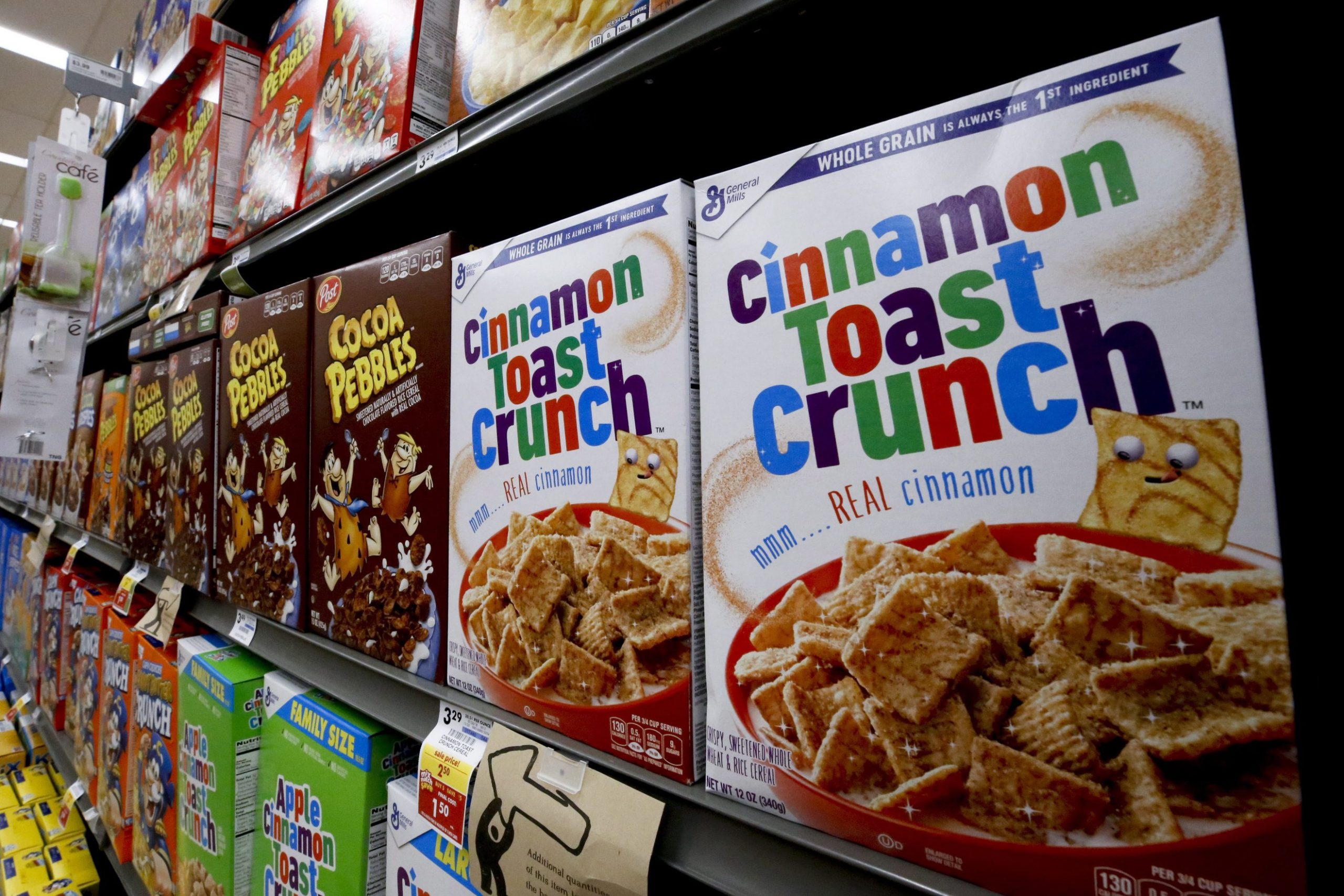 FILE - In this Aug 8, 2018, file photo boxes of General Mills Cinnamon Toast Crunch cereal sit on display in a market in Pittsburgh. (AP Photo/Gene J. Puskar, File)