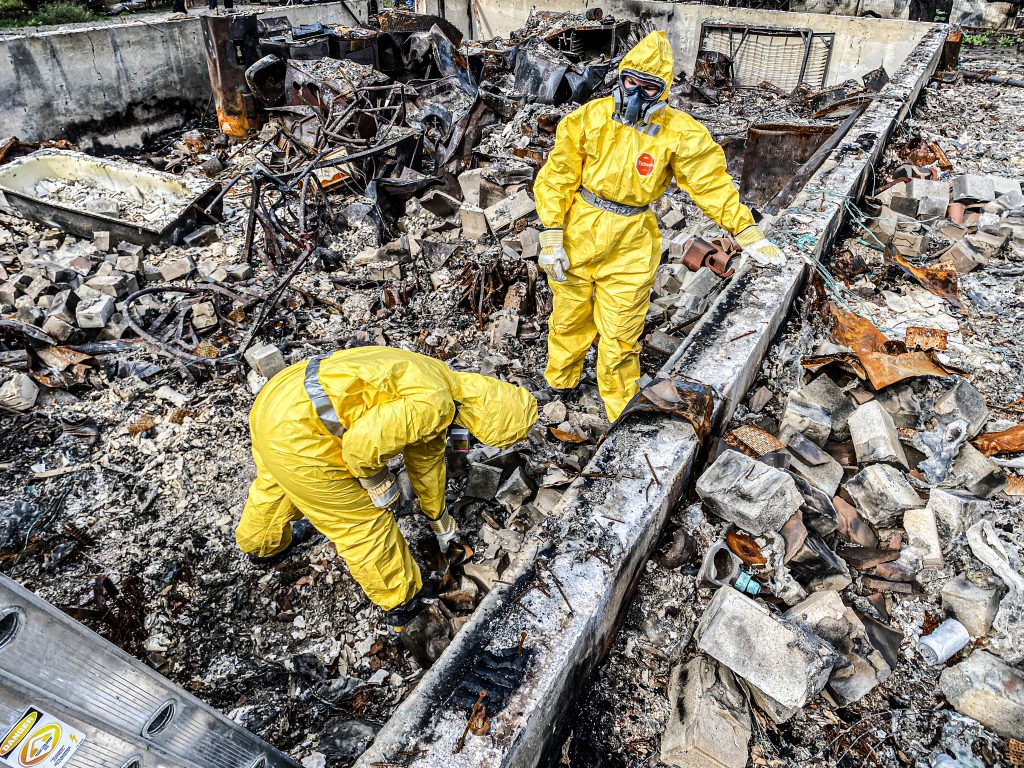 Team Rubicon Canada volunteers sift through rubble and ash to search for people's valuables in Lytton.