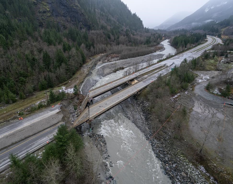 A damaged highway with a bridge semi collapse is pictured with a river running underneath