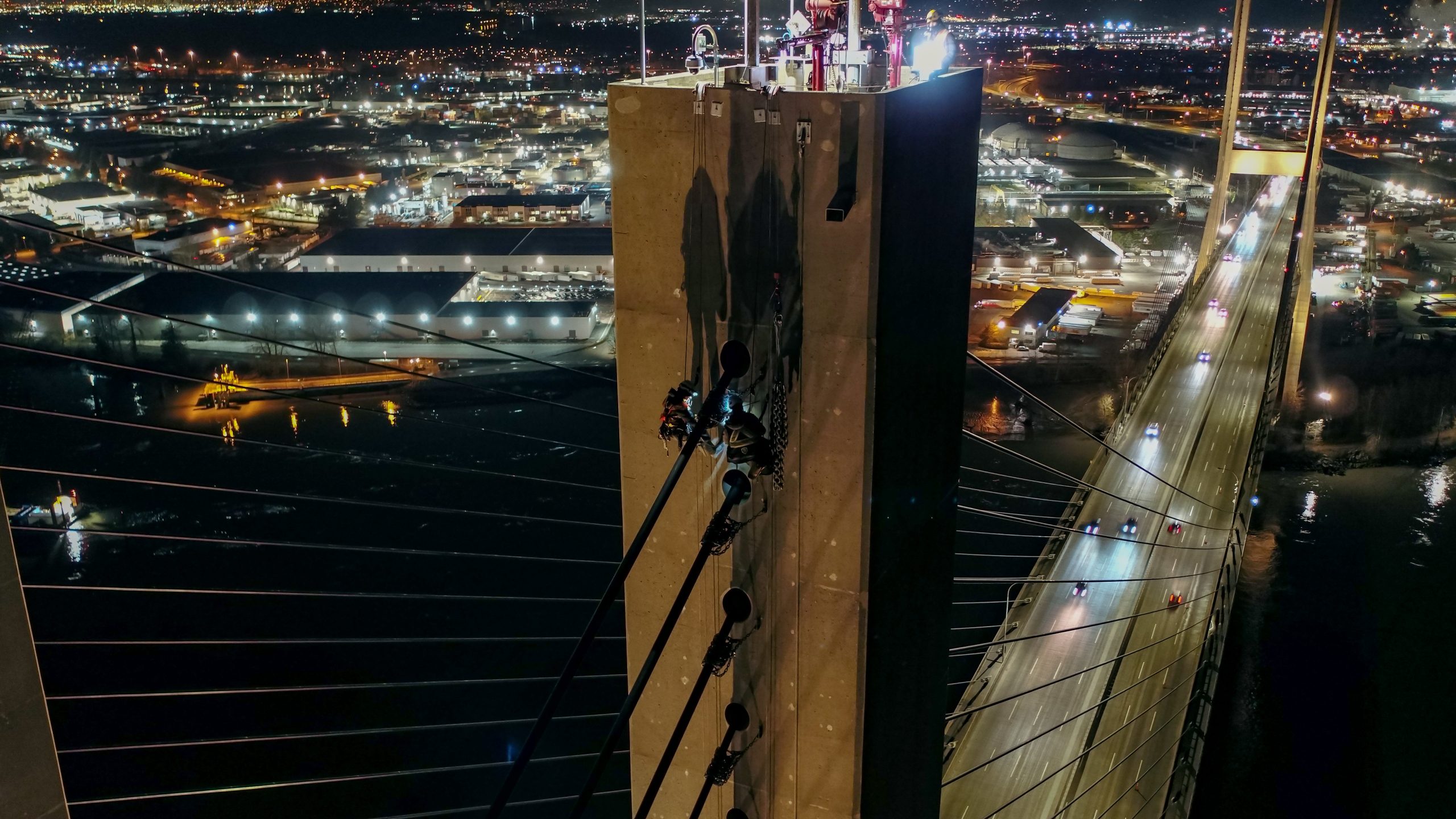 Cable technicians work on the Alex Fraser Bridge