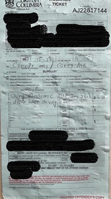 A ticket with black lines blocking out personal information outlines violations under the Motor Vehicle Act