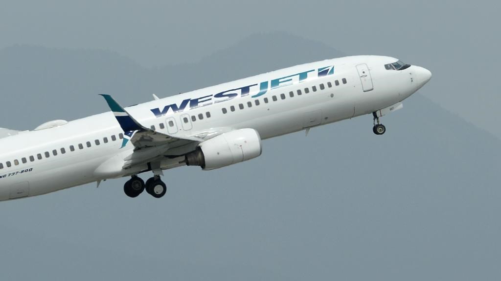FILE -- A WestJet plane takes off from Vancouver International Airport in Vancouver on Monday, May 13, 2019. Onex Corp. has signed a friendly deal to buy WestJet Airlines Ltd. in a transaction it valued at $5 billion, including assumed debt. THE CANADIAN PRESS/Jonathan Hayward