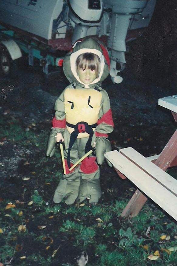 A young child dressed in a Teenage Mutant Ninja Turtles costume 