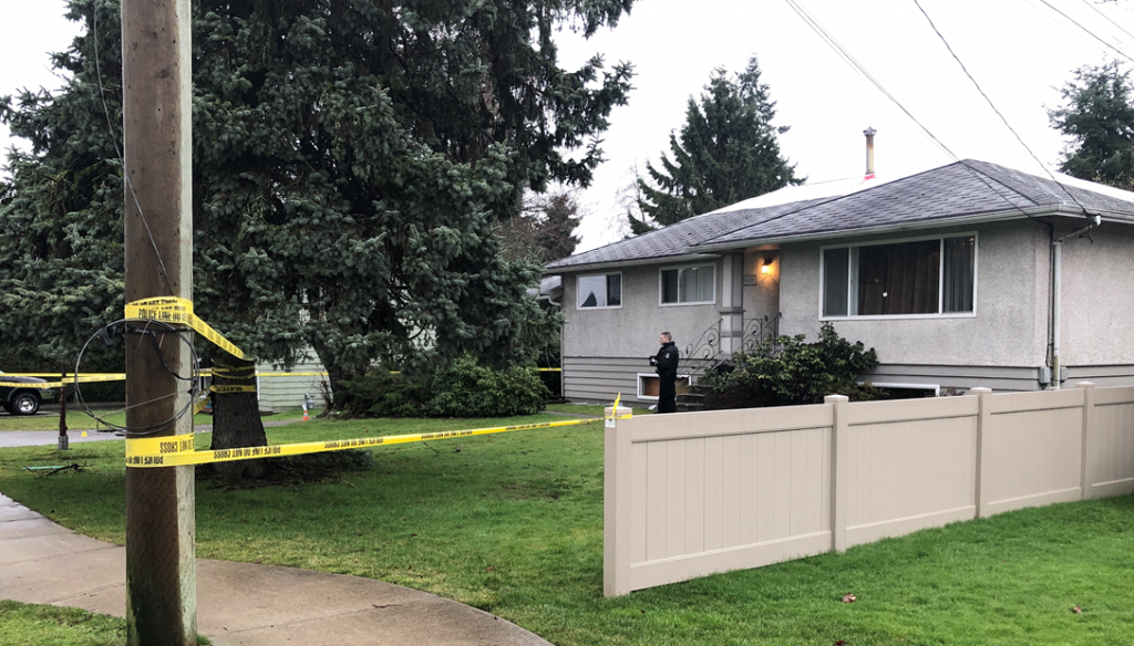 A photo of a home in Delta with evidence markers and police tape after a person was killed early Friday morning