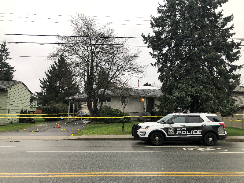 A photo of a Delta police officer outside a home in Delta following a fatal shooting