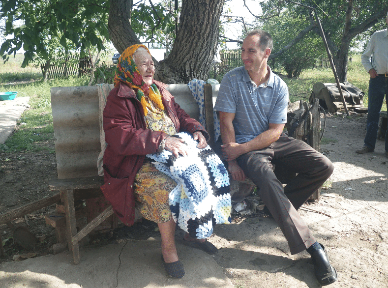 A photo of a Ukrainian woman on the left, with Chad Martz on the right, as the pair talk in Ukraine