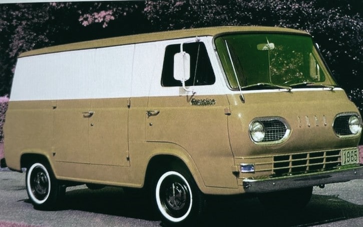 A beige van with white top trim on a road