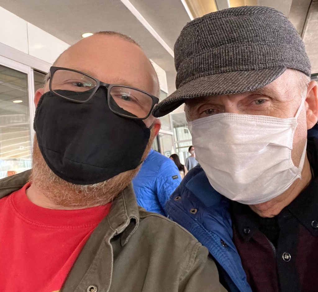 A phot of two men, a father and son, wearing masks who are reunited in Canada after Russia attacked Ukraine