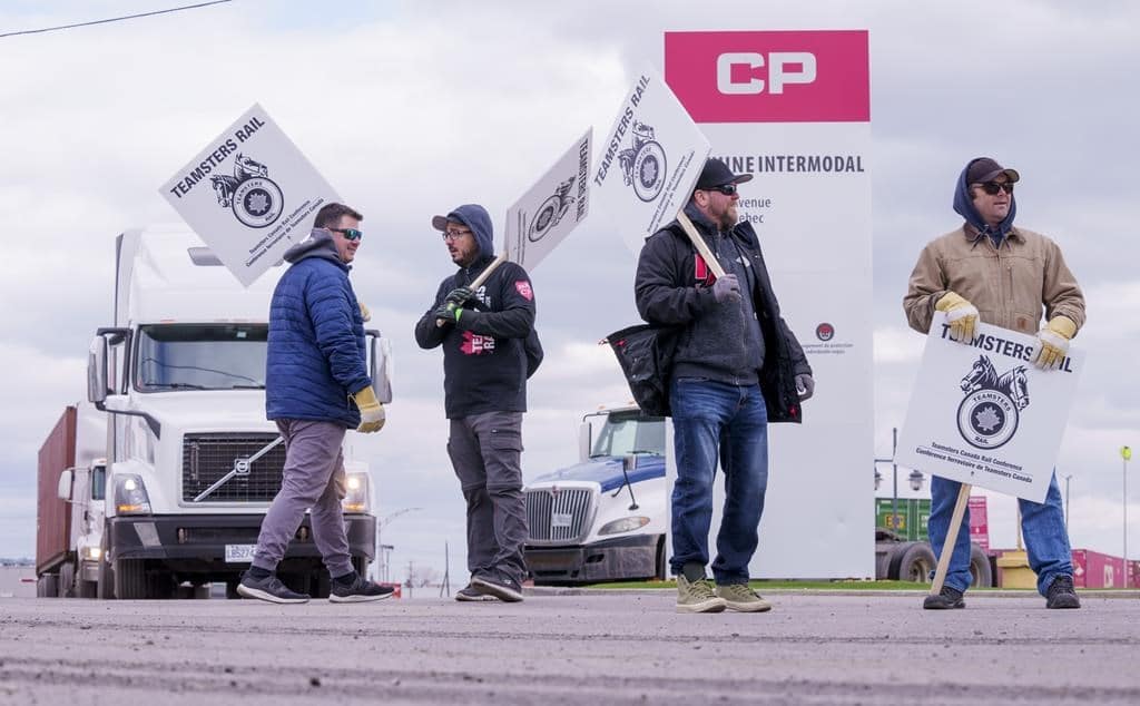 Striking CP Rail workers walk the picket line in Montreal on Monday, March 21, 2022.