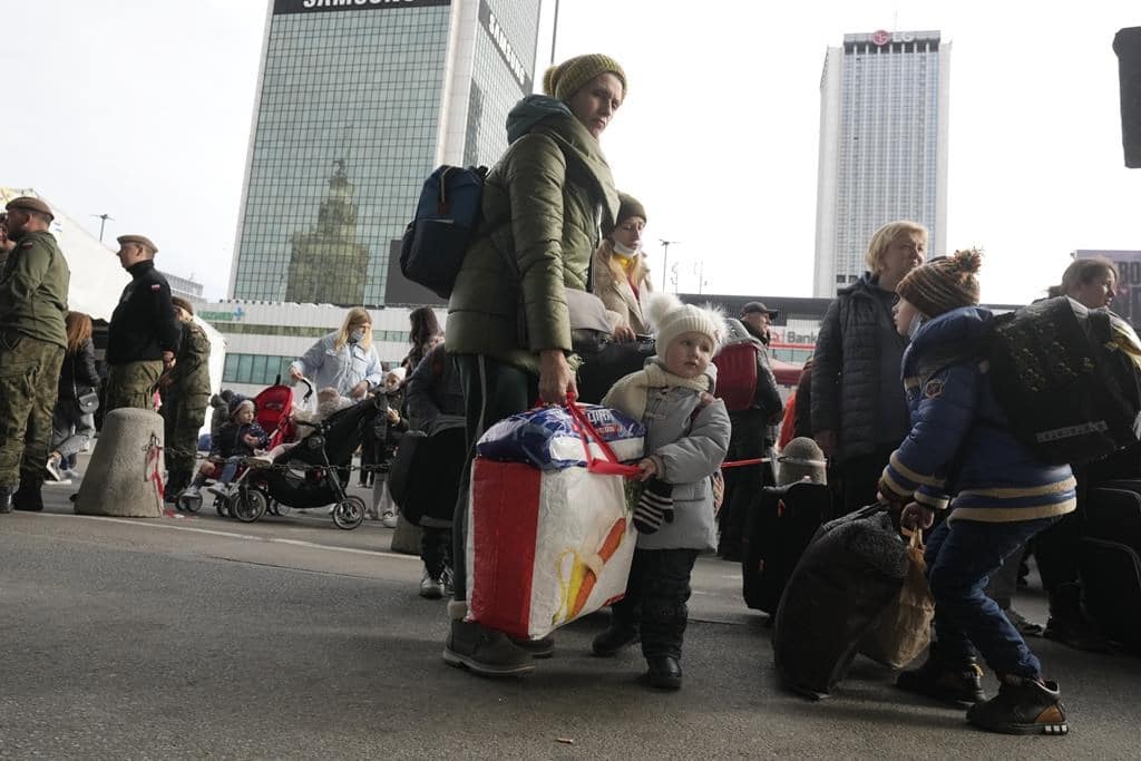 Ukrainian refugees wait for a transport at the central train station in Warsaw, Poland, Sunday, March 27, 2022. More than 3.7 million people have fled the war so far,