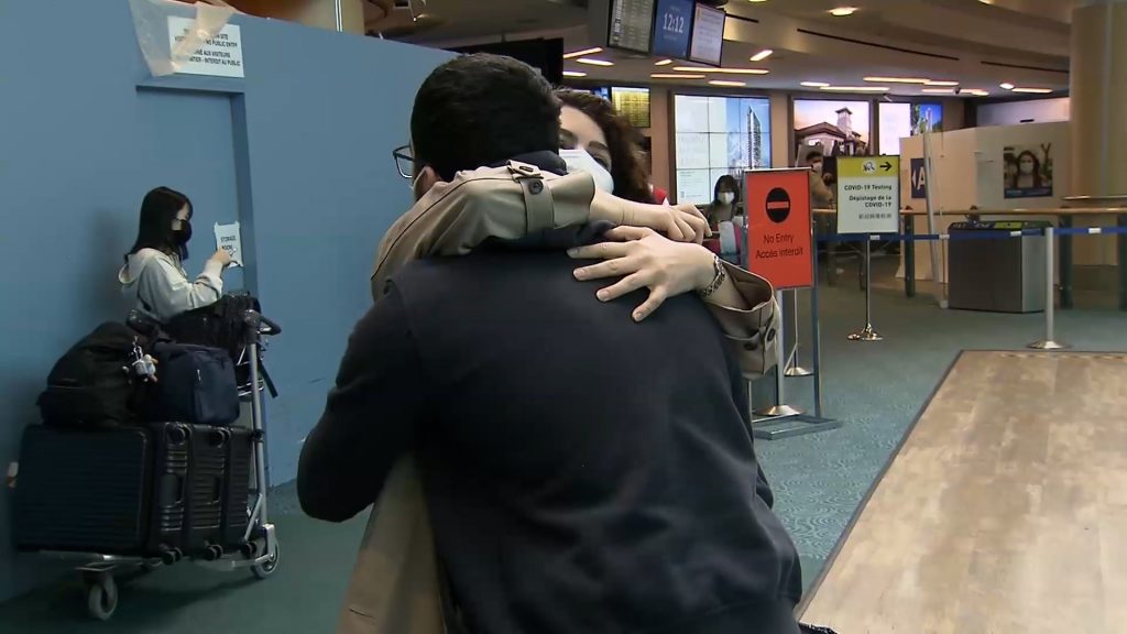 Golnar Arbabi hugs her brother at YVR