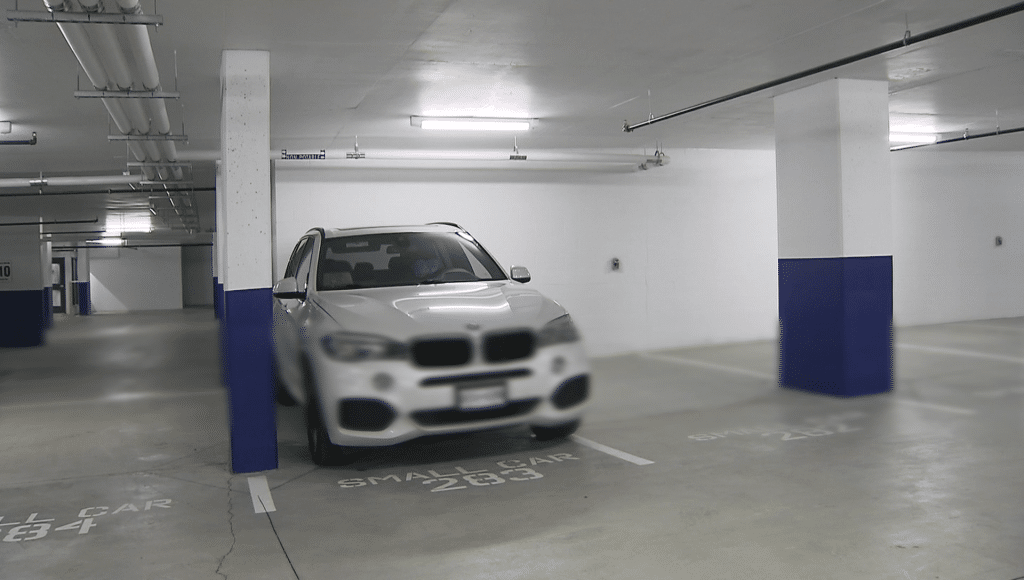 A car parked in a tight spot at a Vancouver condo building