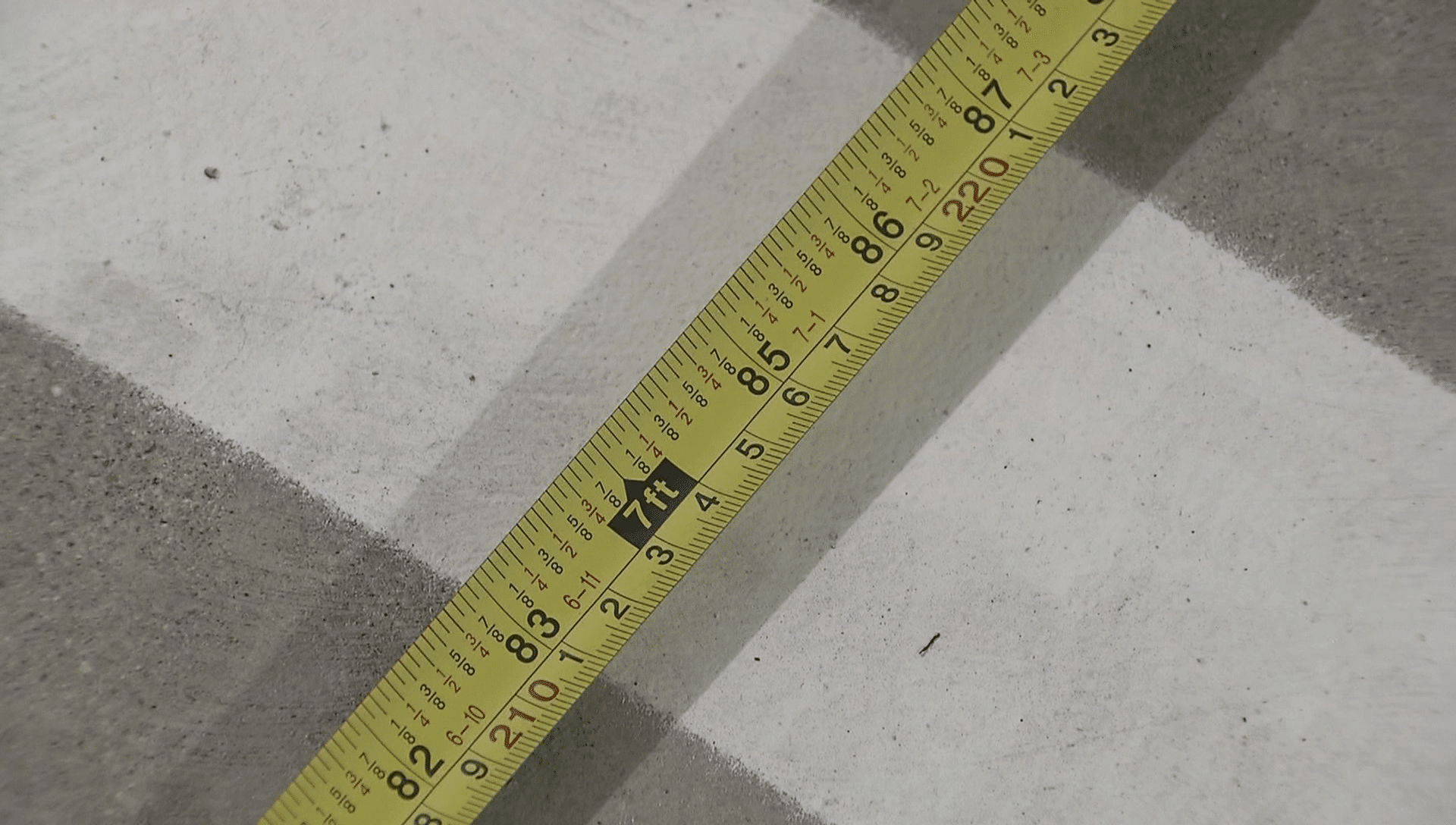 A measuring tape shows a Vancouver resident's parking stall is only 2.1 metres wide 