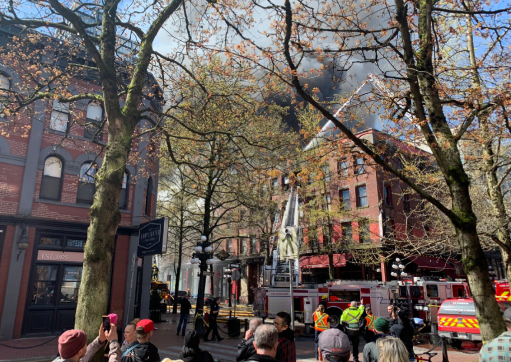 Vancouver firefighters douse flames at the Winters Hotel in Gastown, above the Flying Pig restaurant