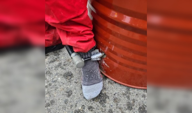 A protester on Highway 1 in Burnaby locked his ankle to a barrel full of concrete, police say