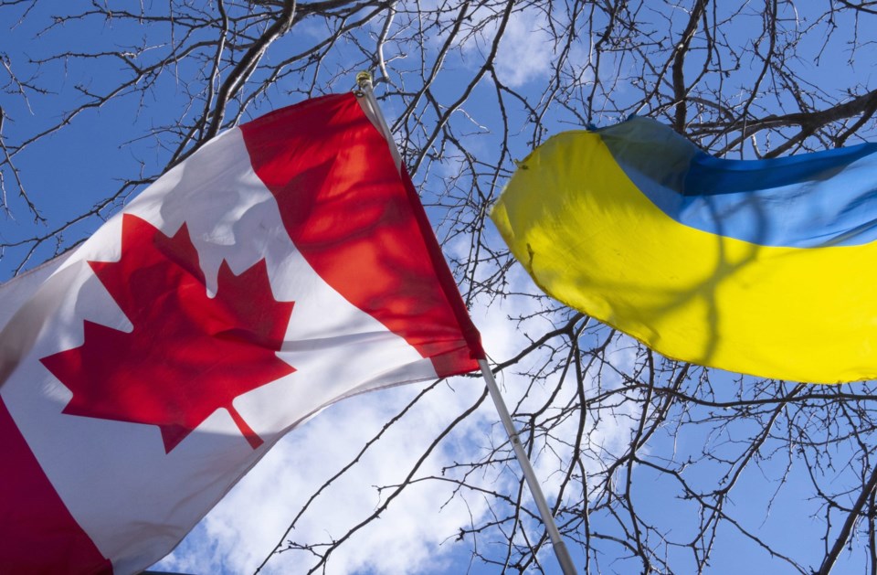 Canadian and Ukrainian flags flutter in the sunshine outside a Ukrainian restaurant in Toronto on Wednesday, March 2, 2022. THE CANADIAN PRESS/Frank Gunn