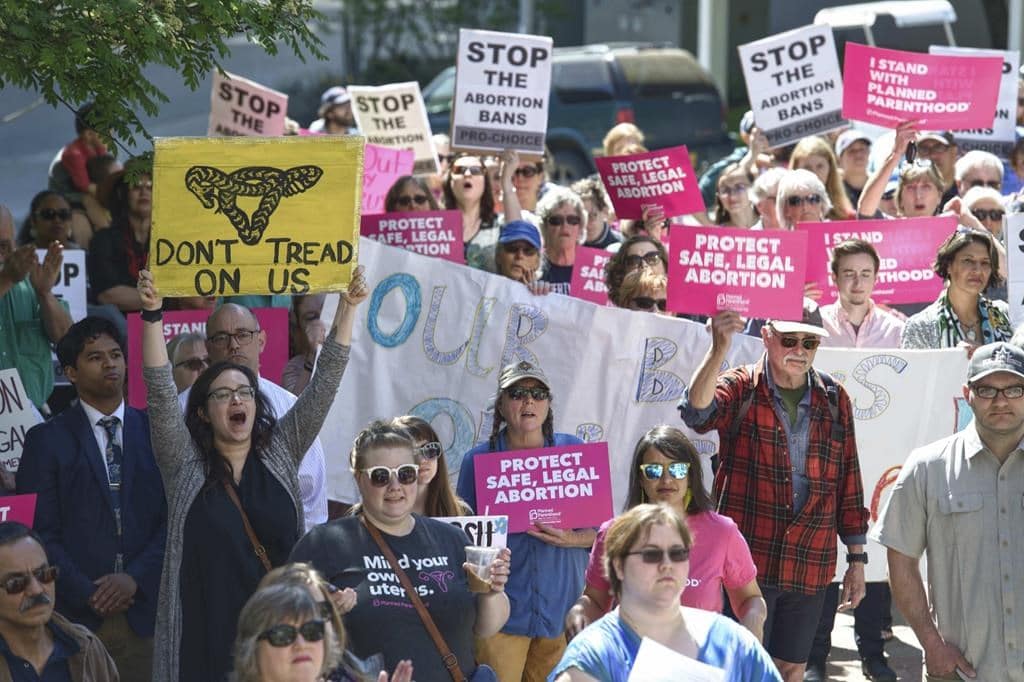 This May 21, 2019, photo shows people attending a rally against anti-abortion laws at the Dimond Courthouse Plaza in Juneau, Alaska. (Photo by Michael Penn, Juneau Empire via AP)