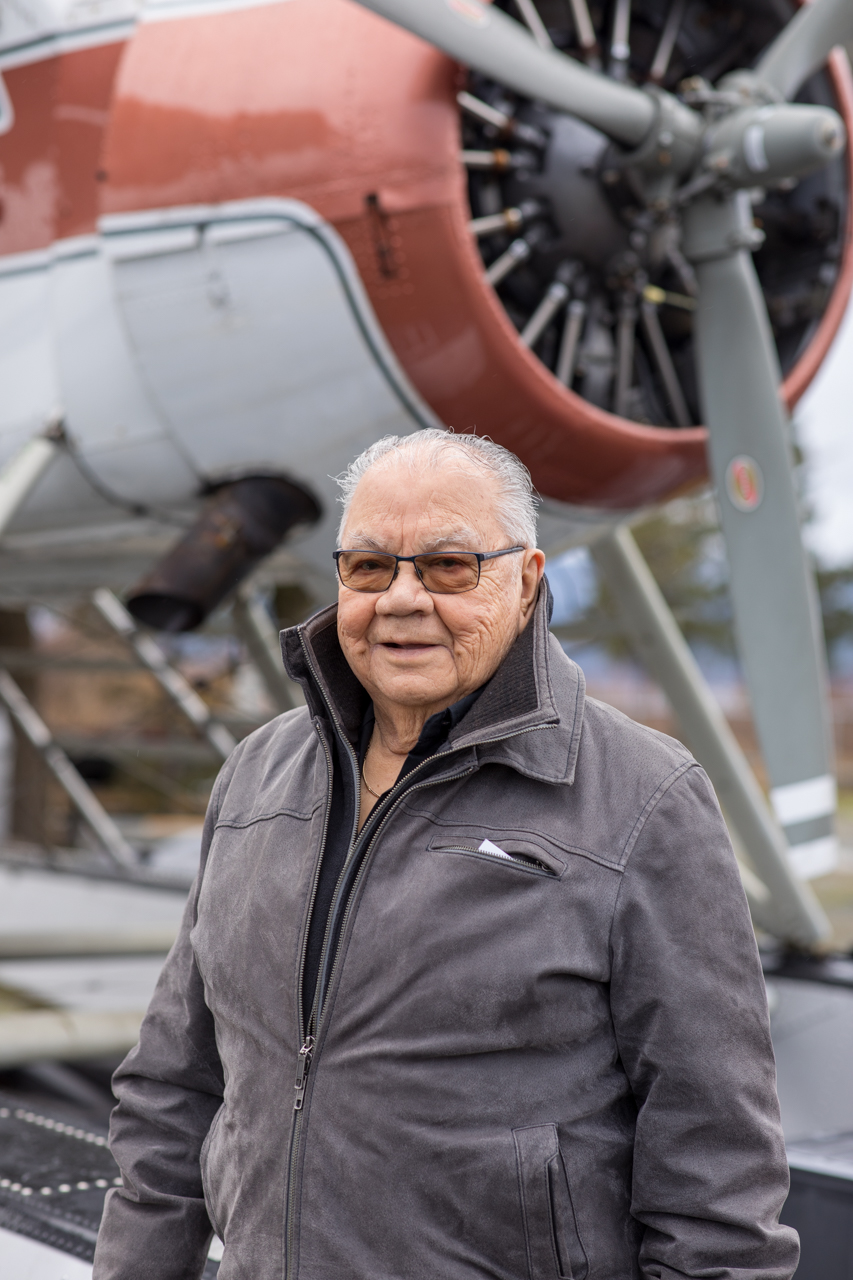 Barney Williams, the 2022 Courage To Come Back Award recipient in the Addictions category, smiles while standing next to a plane engine