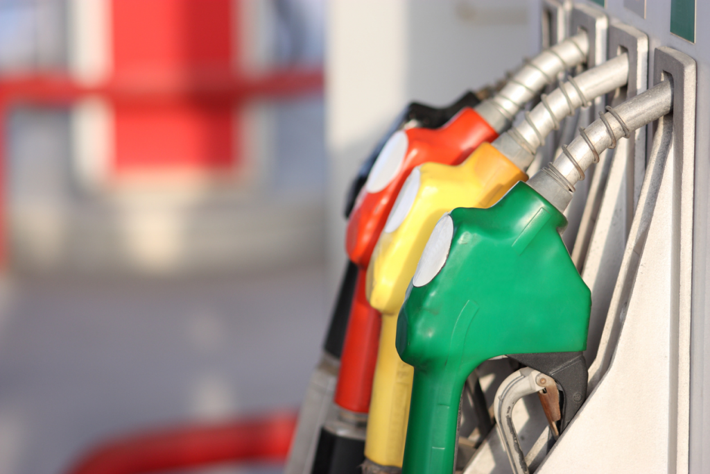 a photo a diesel, gas, a gas station and the background of a sign.