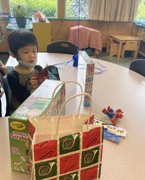 Max, who is on the autism spectrum, playing with toys at a table. 