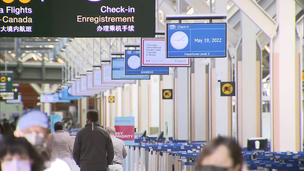 The inside of YVR airport with a sign reading "check-in".