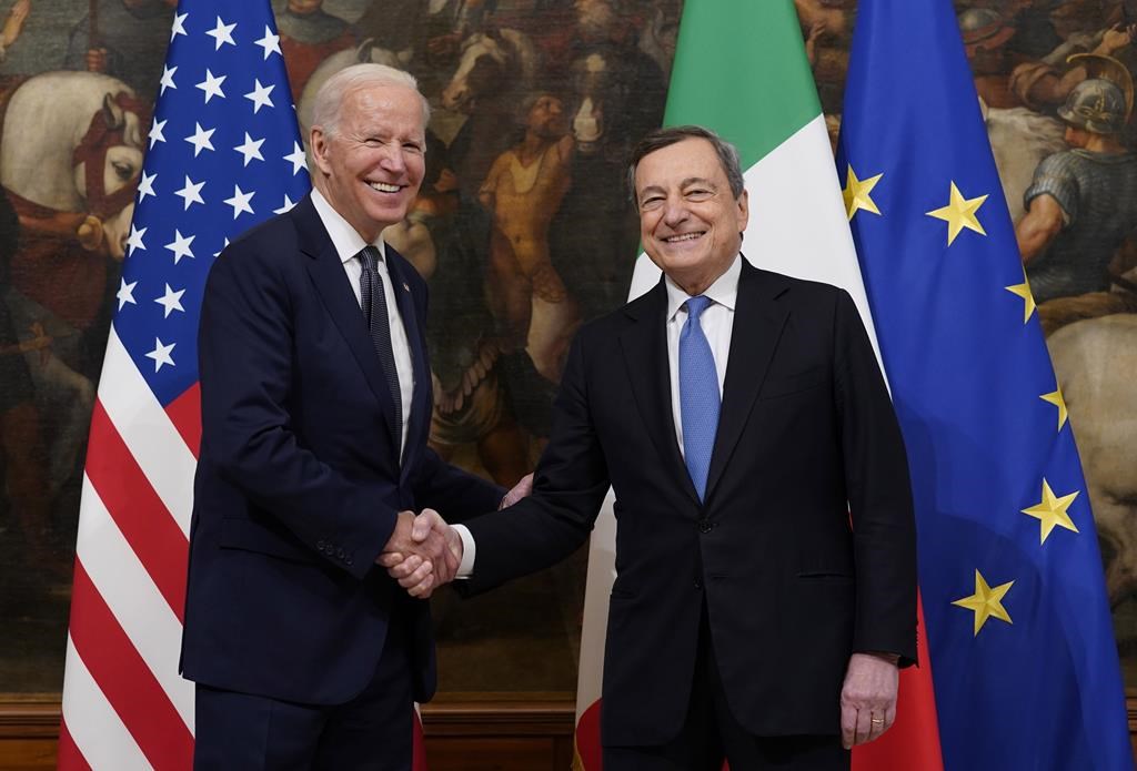 FILE - U.S. President Joe Biden, left, shakes hands with Italy's Prime Minister Mario Draghi prior to a ceremony at the Chigi Palace in Rome, Friday, Oct. 29, 2021. Italian Premier Mario Draghi meets with U.S. President Biden this week in Washington, D.C., as Europe faces another “whatever it takes” moment, with war raging on its eastern flank in Ukraine. (AP Photo/Evan Vucci, File) 