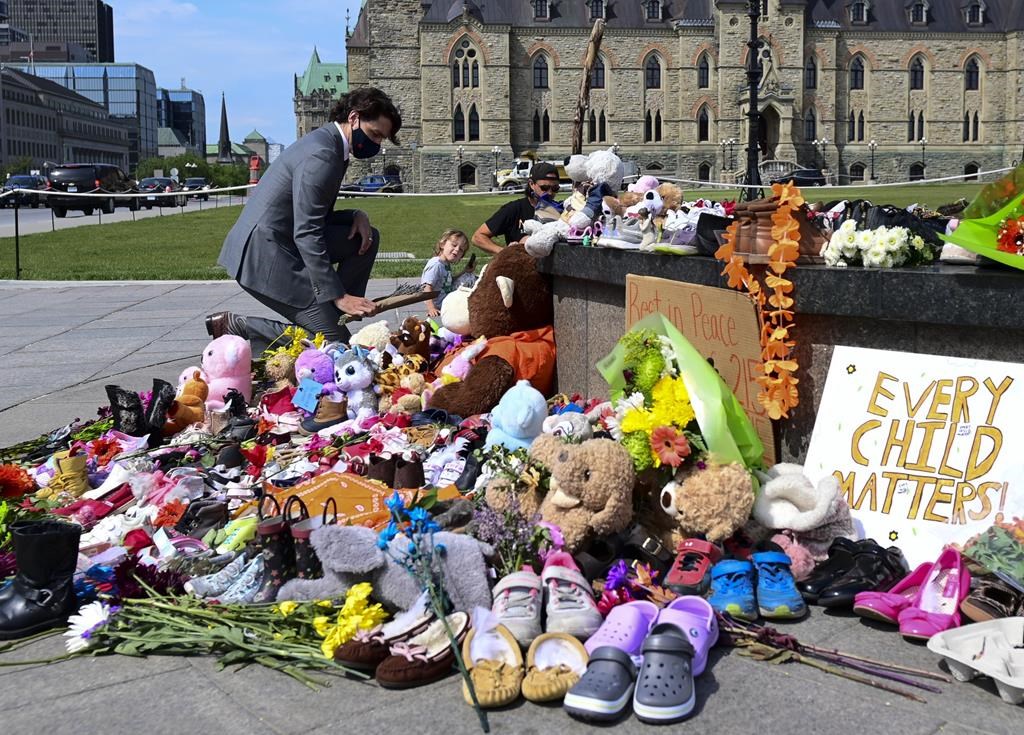 Prime Minister Justin Trudeau visits a memorial at the Eternal flame on Parliament Hill in Ottawa on Tuesday, June 1, 2021, that's in recognition of discovery of children's remains at the site of a former residential school in Kamloops, B.C. THE CANADIAN PRESS/Sean Kilpatrick 