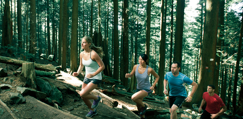 A photo of three people running up the Grouse Mountain Trail