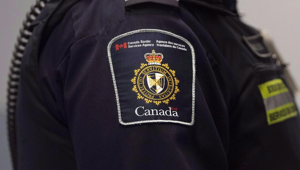 A CBSA patch is seen on the arm of a customs officer