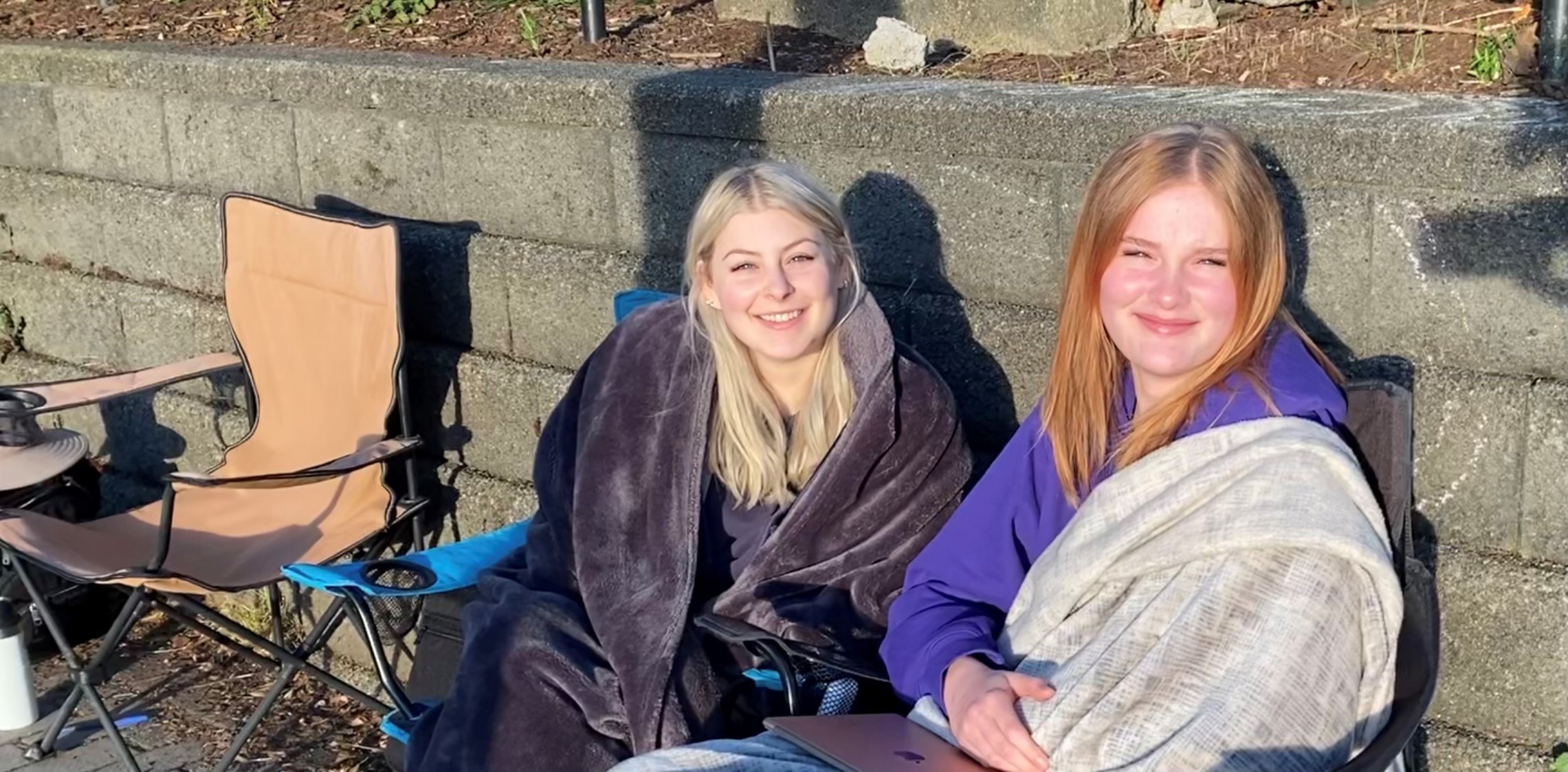 Waiting for hours since 5:00 a.m., Avary Vinciguerra and her friend are hopeful they might still get to go to Mexico. (Robert Henning)