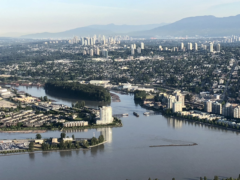 A photo of Burnaby, Queensborough, New Westminster and the Fraser River from a helicopter, with Vancouver in the far distance. June 27, 2022.(Twitter/@DangerOnAir)