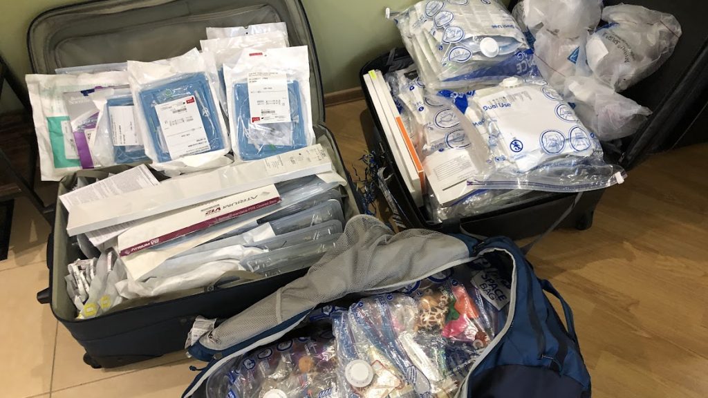 Various medical items are pictured in three duffle bags