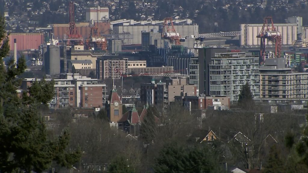 Buildings and homes are seen in the distance with trees in the foreground