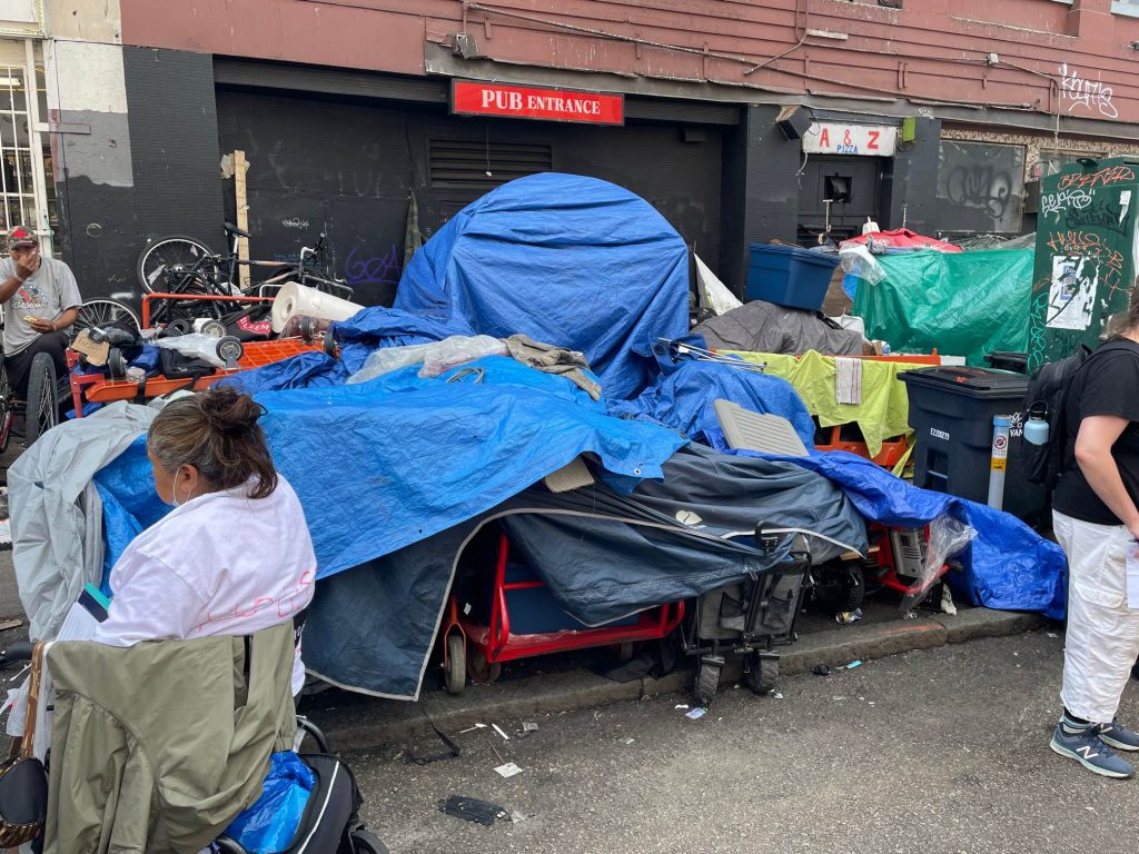 Tents and other structures piled up in an alleyway as belongings are removed from East Hastings in Vancouver