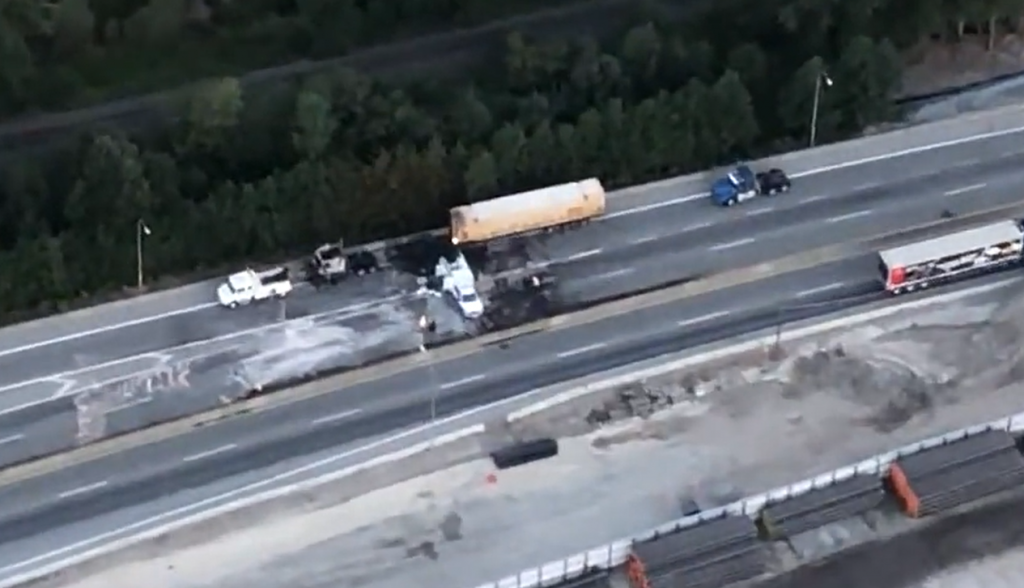 Cleanup along a highway is pictured from above as lanes are closed after a semi truck caught on fire