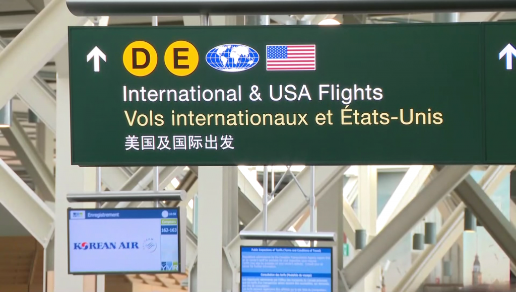 A sign reading "international and USA flights" at YVR.