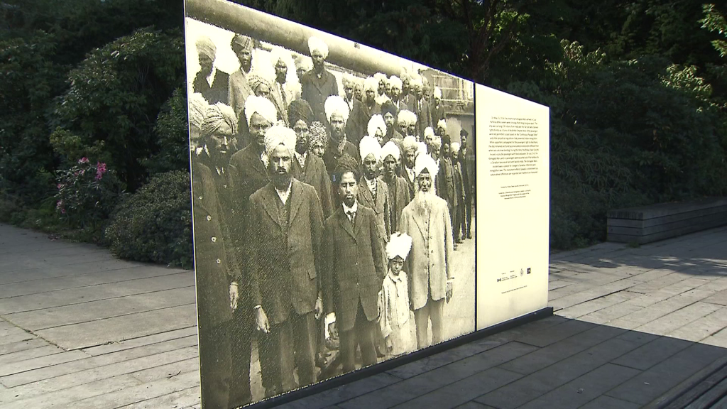 A glass memorial with the photo of a group from the Komagata Maru ship