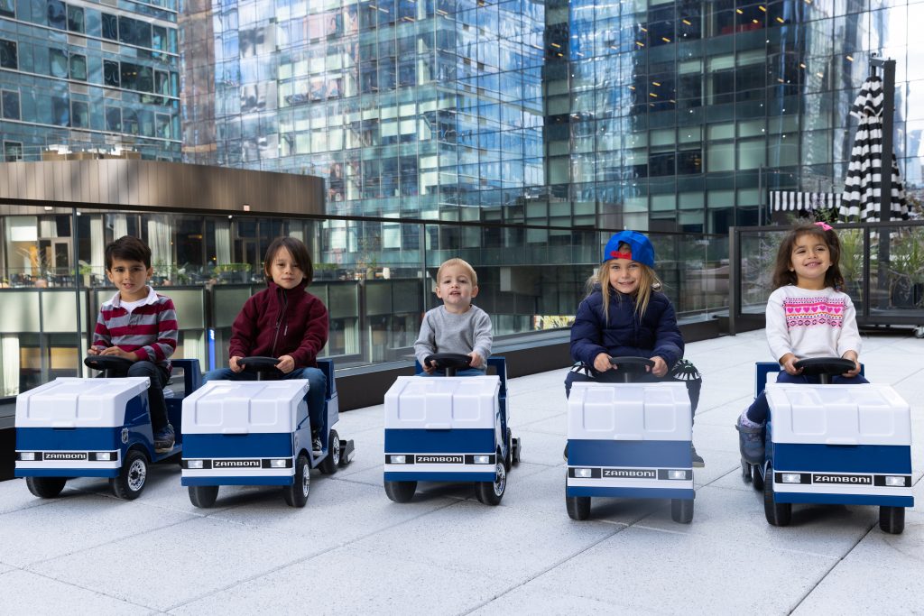 Five young kids riding replica Zamboni machines