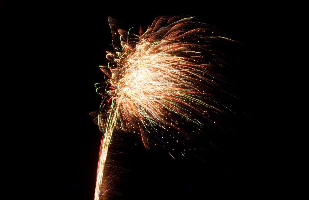 A firework is set off against a dark sky