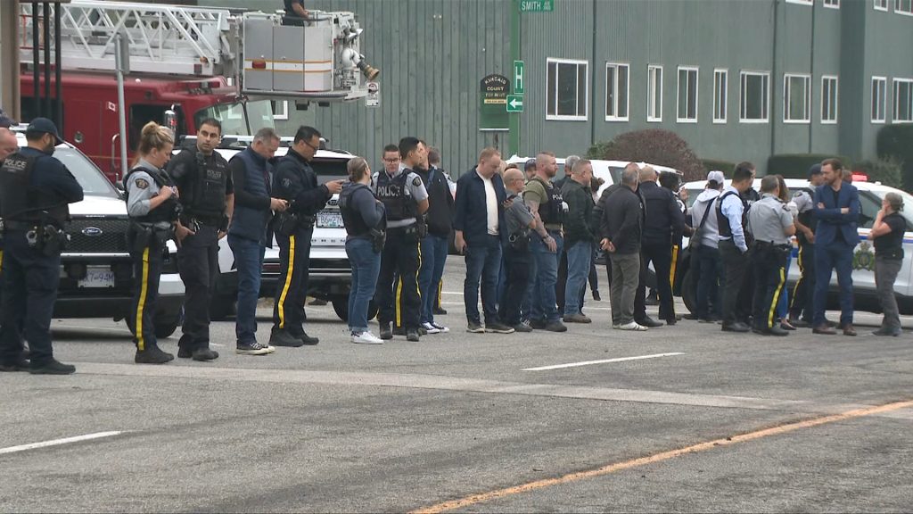 Police cars and officers line a street during a procession for Burnaby RCMP Const. Shaelyn Yang, who was killed in the line of duty