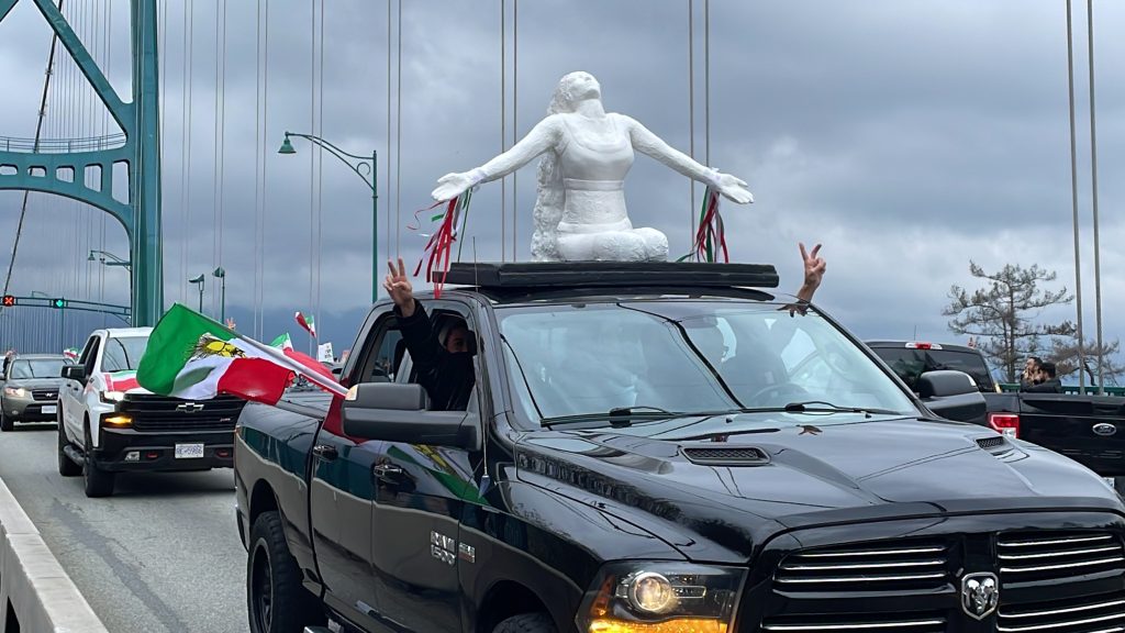 Hundreds of demonstrators lined up along the Lions Gate Bridge into the Stanley Park Causeway Saturday calling for an end of the Iranian regime