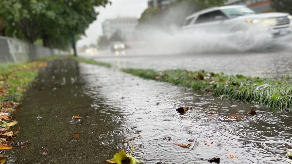 A car splashes water as it speeds by in Vancouver