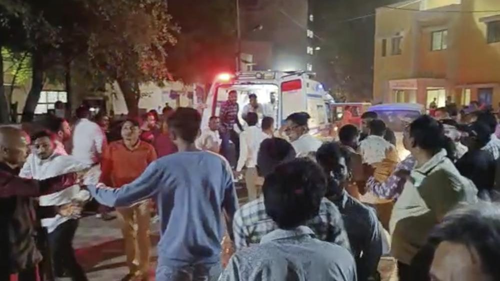 This image from video shows the commotion outside a hospital where victims of a cable bridge collapse are being rushed in for treatment in Morbi district, western Gujarat state, India, Sunday, Oct.30, 2022. Dozens are feared dead and several injured when a cable bridge across the Machchu river collapsed Sunday.