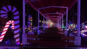 inside of a train with christmas decorations all on the outside 