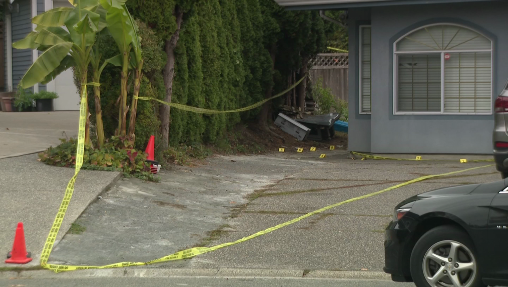 Police tape is seen on a driveway