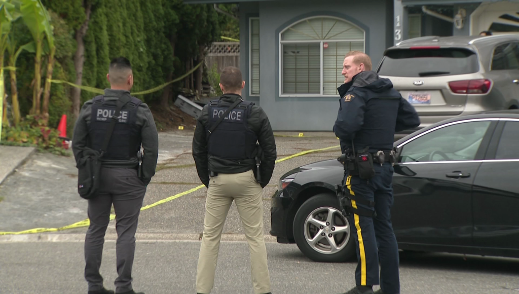 Police stand in front of a crime scene