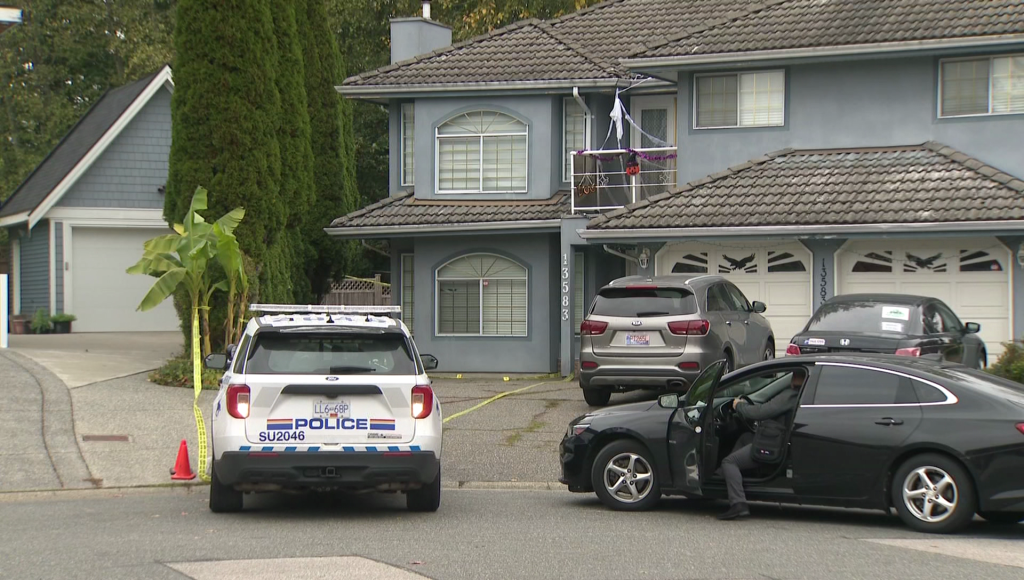 A house with a RCMP vehicle in front of it