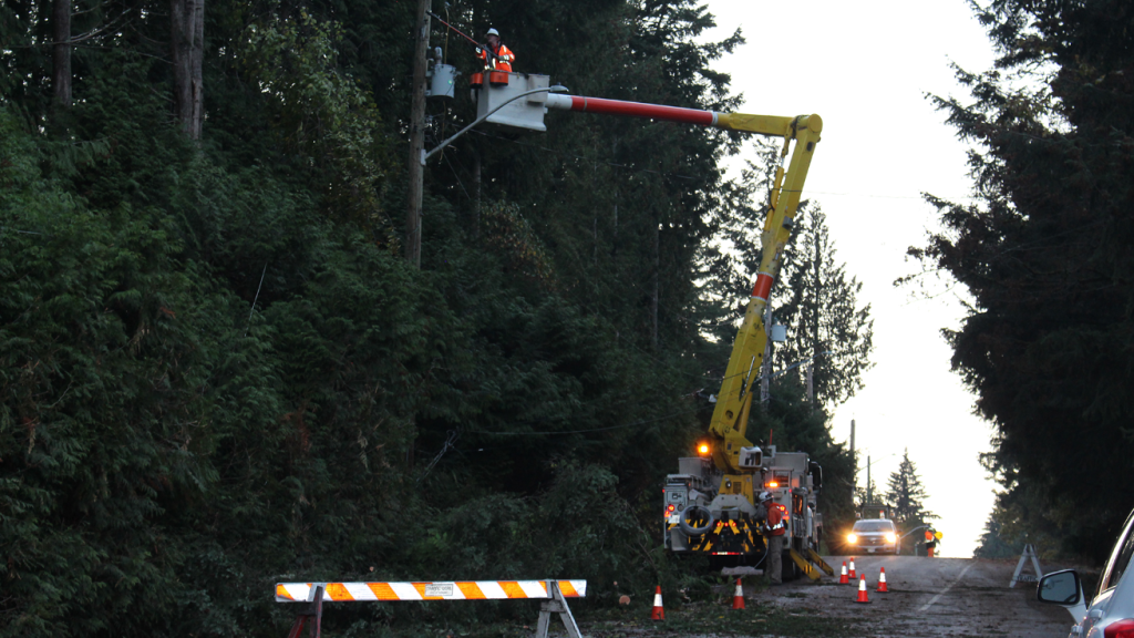 A BC Hydro worker elevated while working on a power transformer.