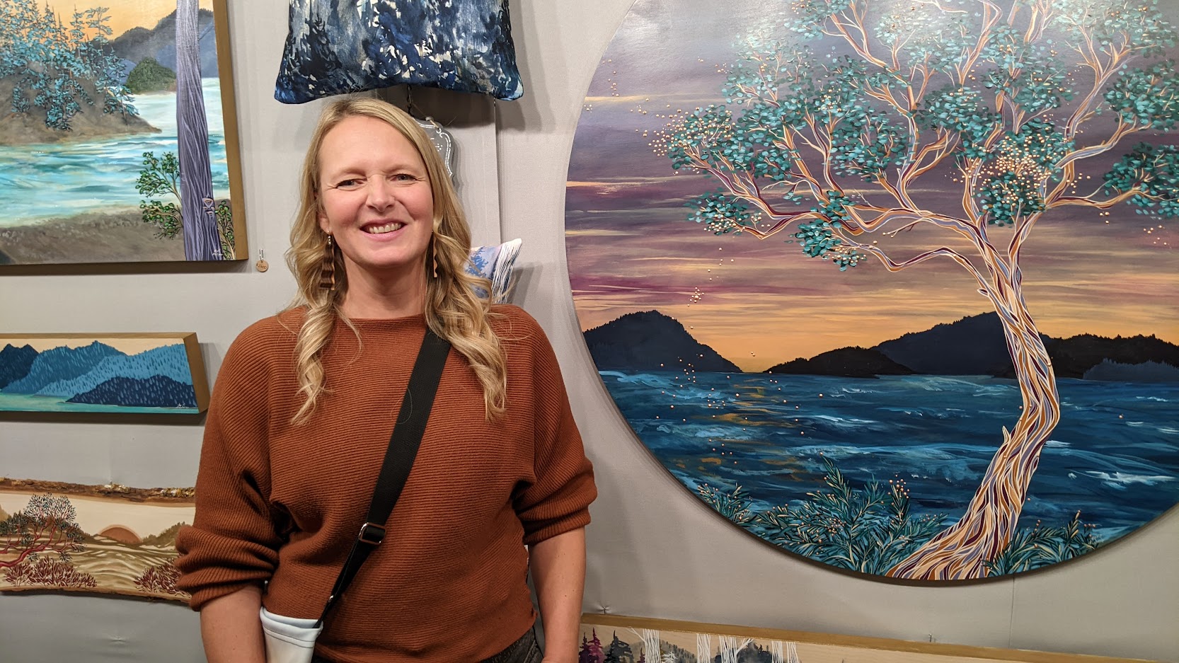 April Lacheur posing next to some of her work at the Circle Craft Christmas Market at the Vancouver Convention Centre