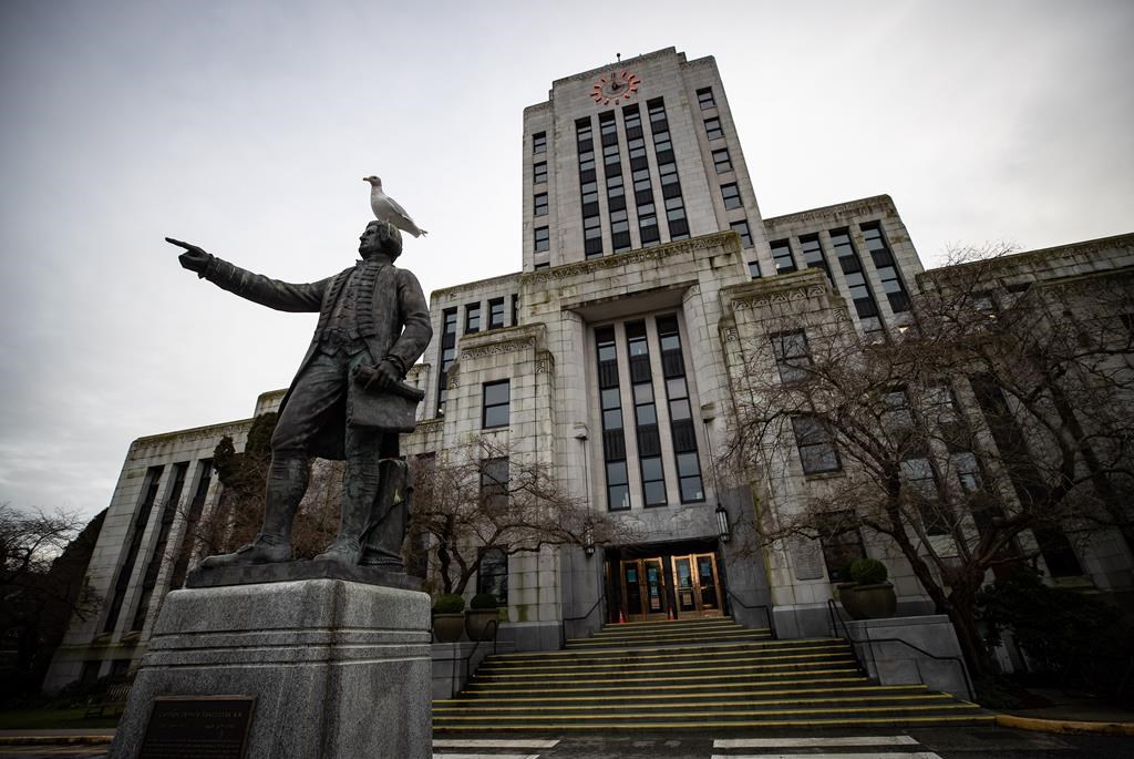 A seagull stands atop a statue of Captain George Vancouver outside Vancouver City Hall, on Saturday, Jan. 9, 2021